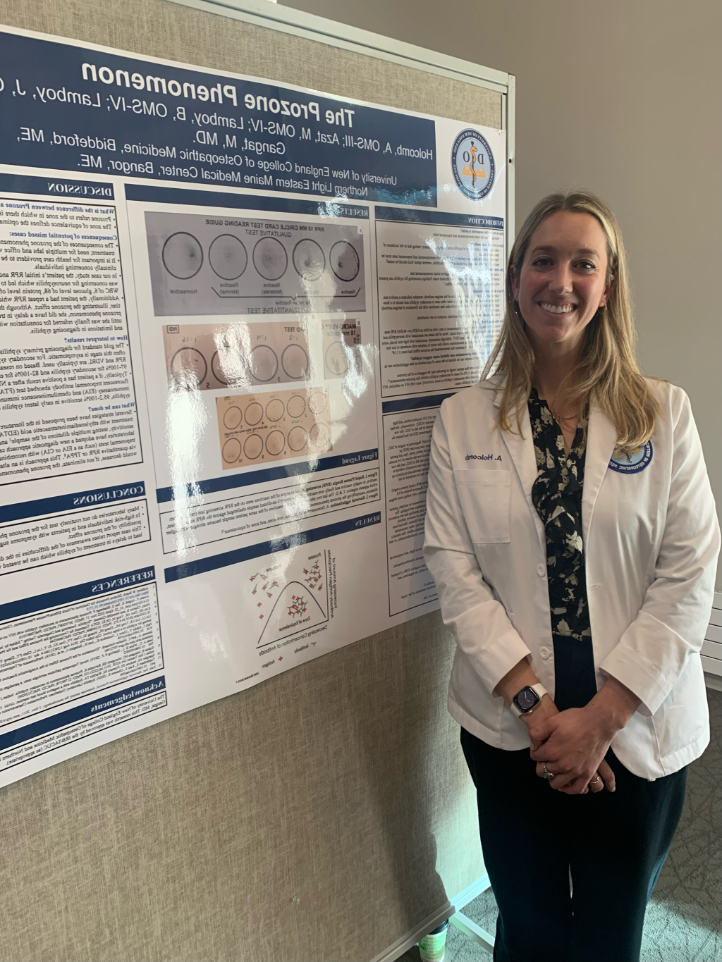 Anna Holcomb poses in front of her poster