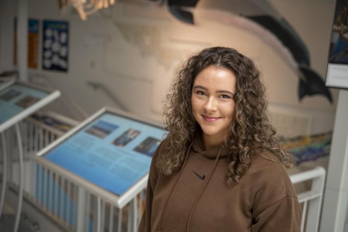 Portrait of Isabella Dube (Marine Affairs, ’24) in UNE's Marine Science Center